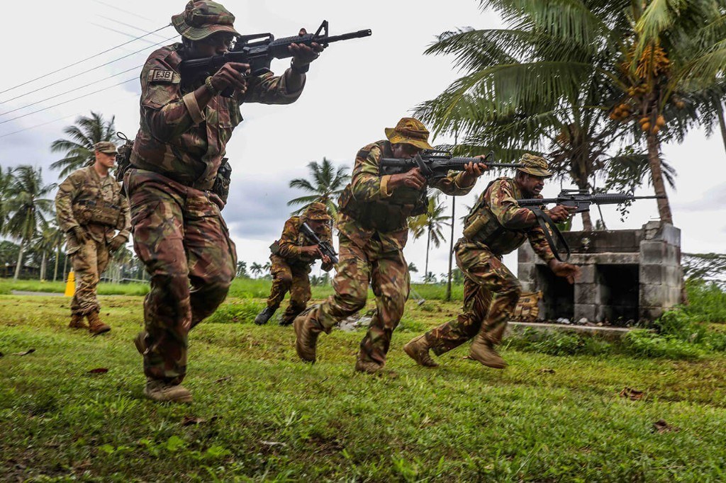 Soldiers training together in the field